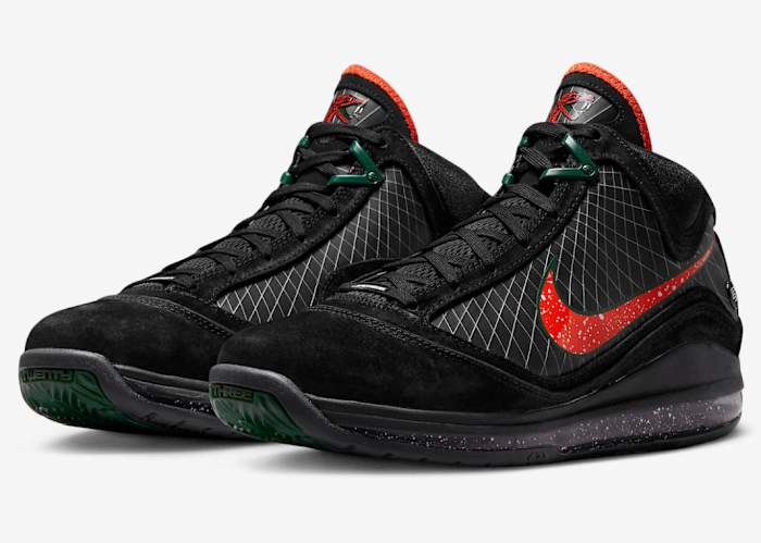Side view of LeBron James' black, orange, and green Nike shoes.